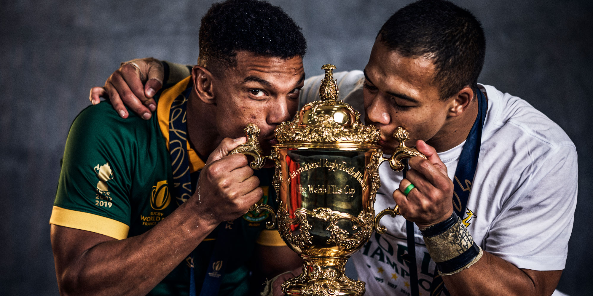 Two former Blitzboks, Kurt-Lee Arendse and Cheslin Kolbe, with the Webb Ellis Cup.